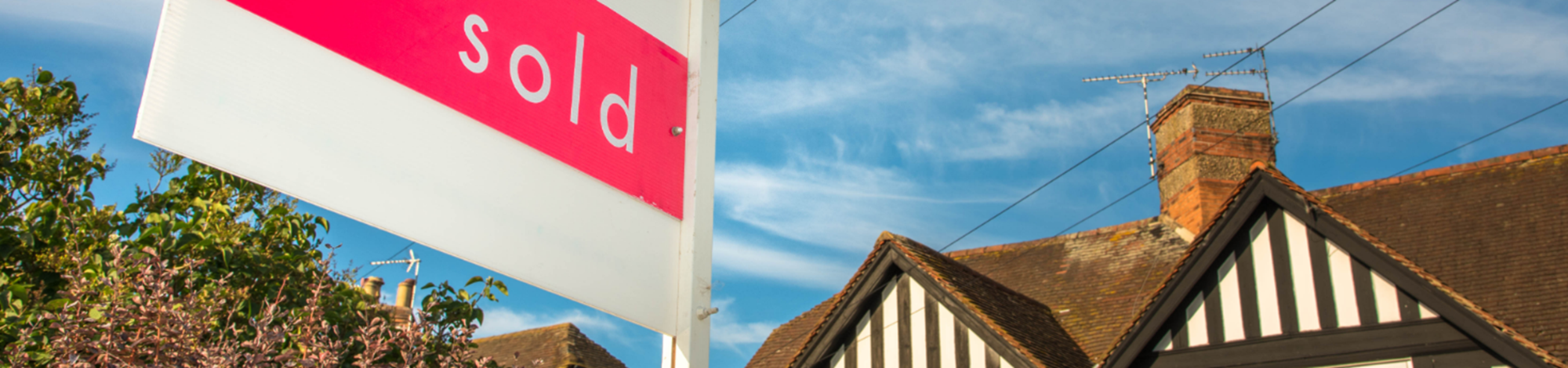 A sold sign in front of a house