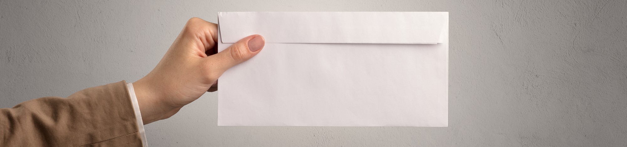 Person holding envelope