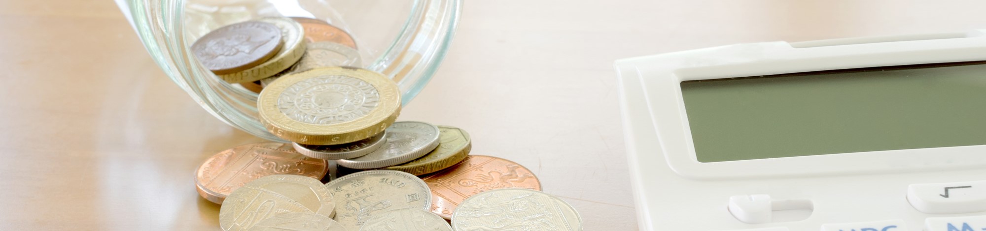 Coins next to a calculator