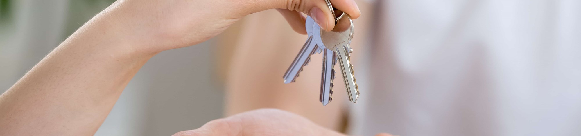 Handing over a set of house keys, freehold and leasehold