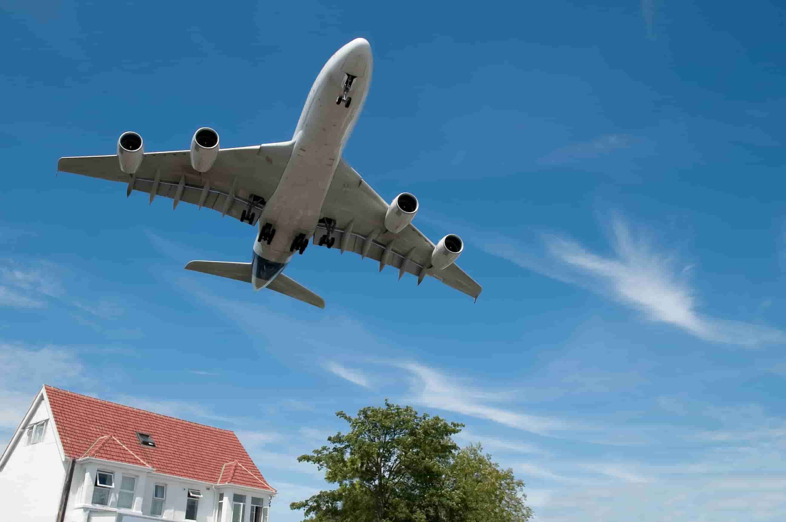 plane flying over house