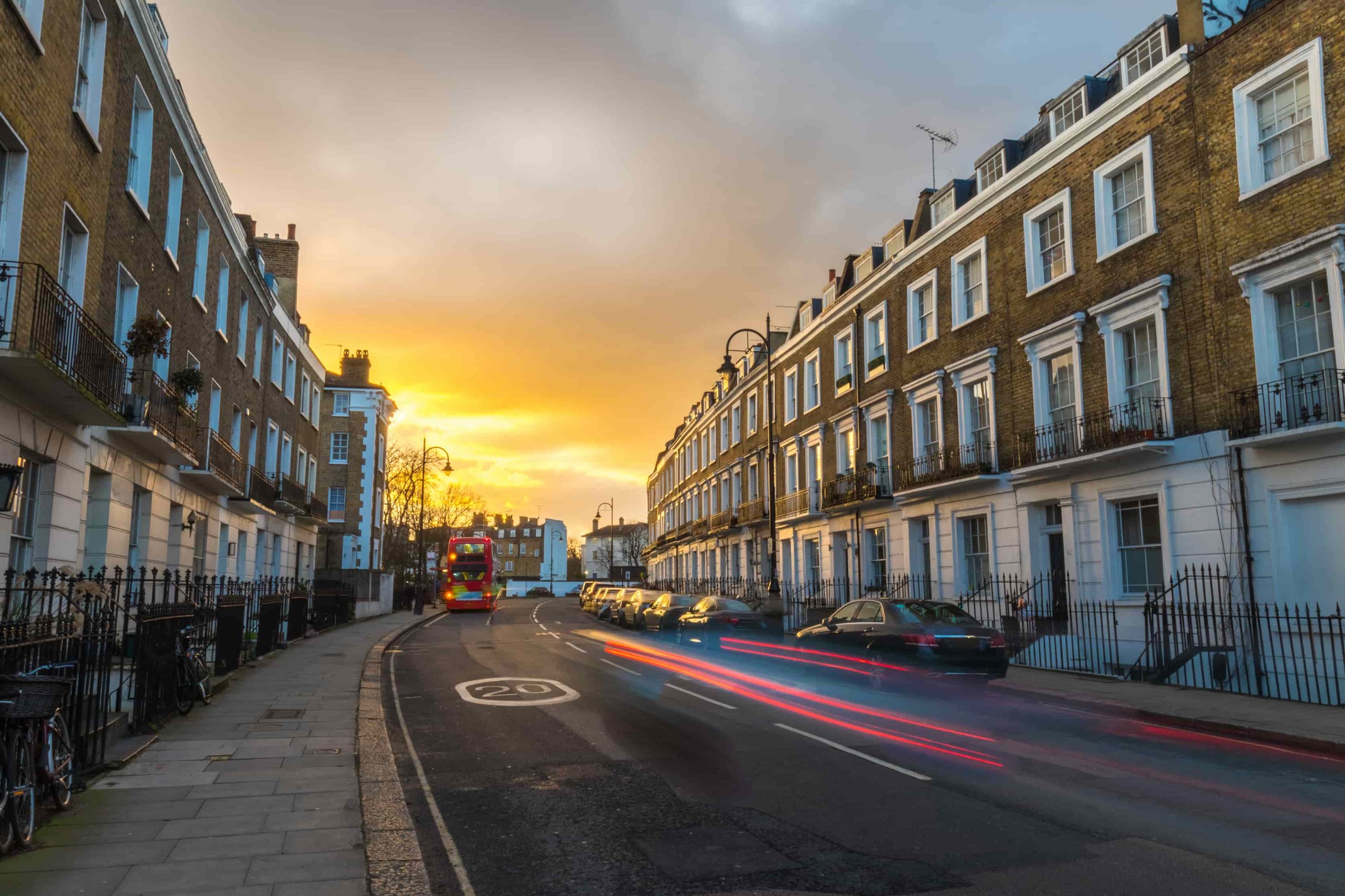 Block of flats at sunset and the light of the cars marking lines during the long exposure at rush hour