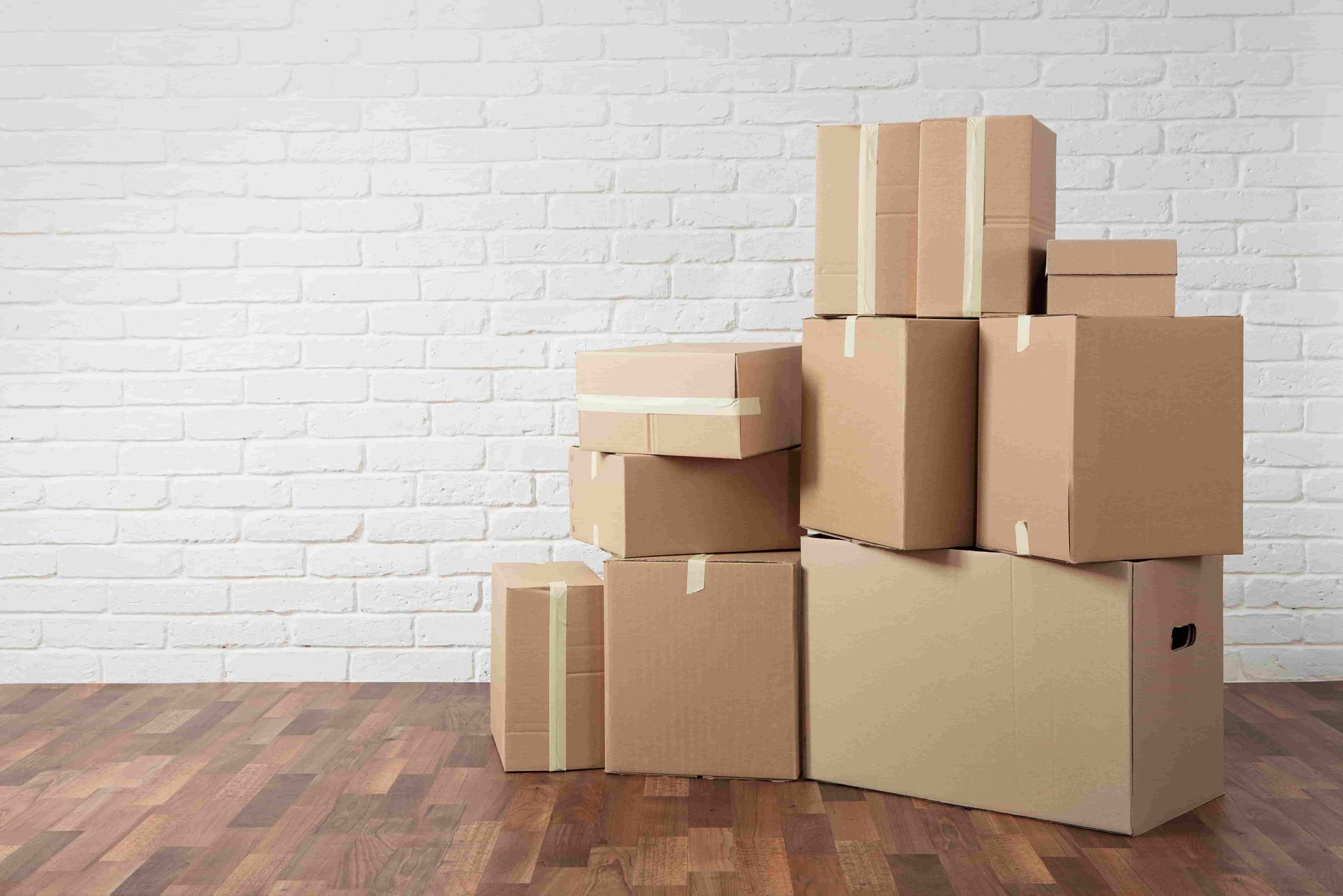 Moving in. Stack of cardboard boxes in the empty room