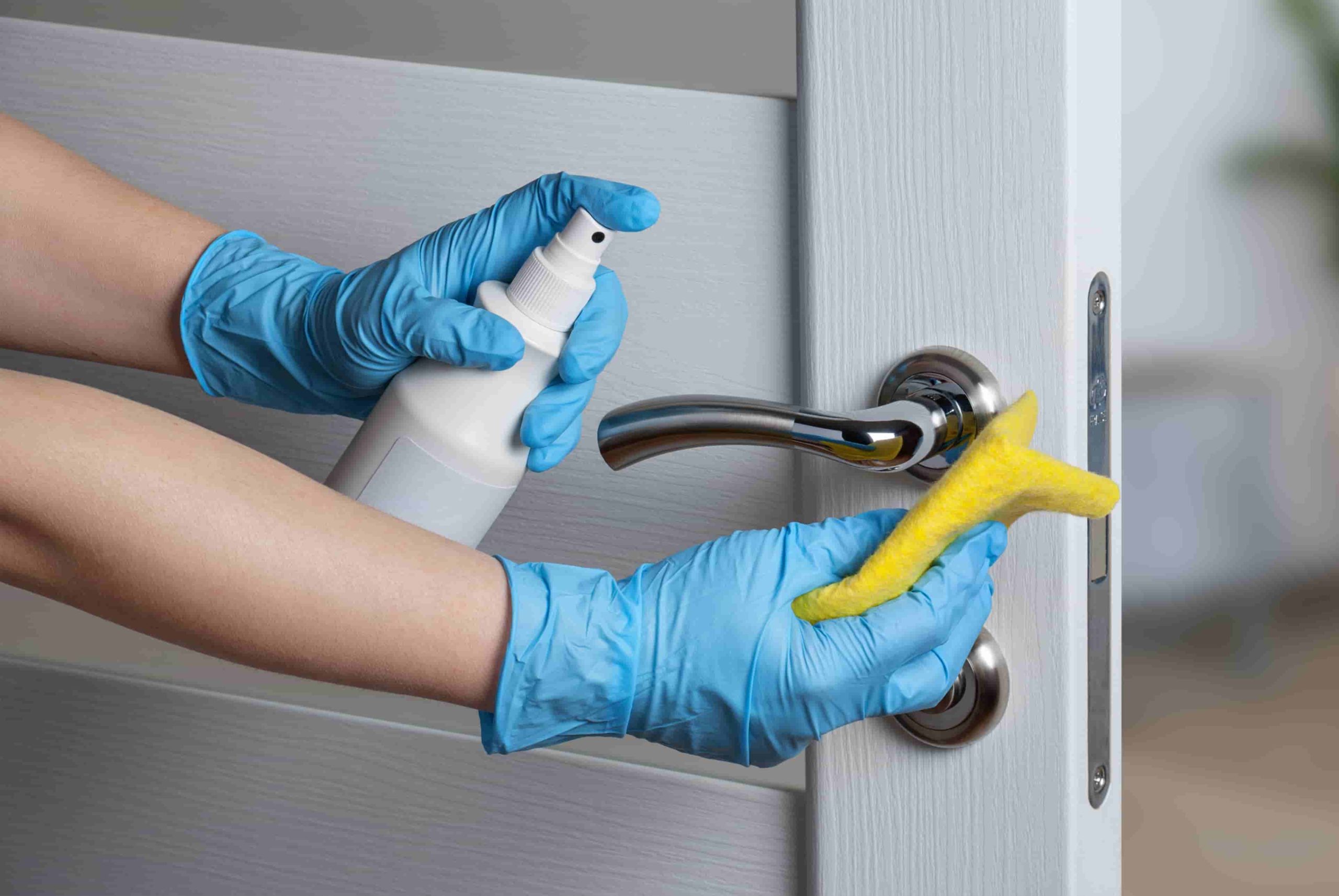 Cleaning door handles with an antiseptic during a viral epidemic