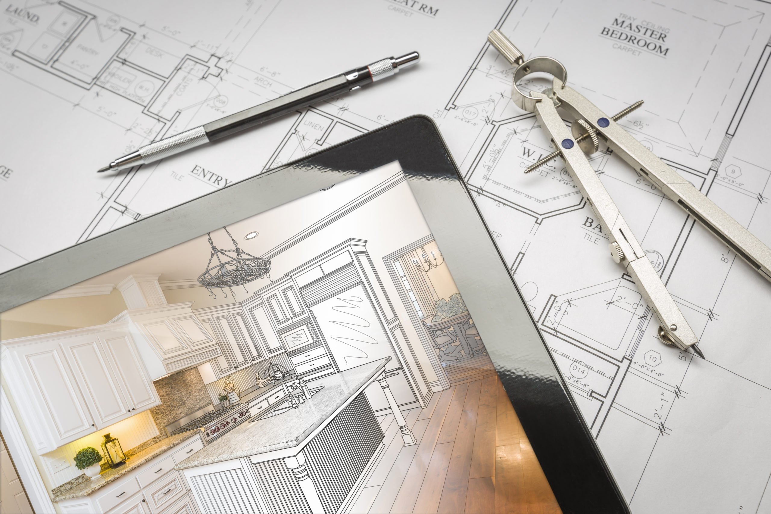 Computer Tablet Showing Kitchen Illustration Sitting On House Plans With Pencil and Compass