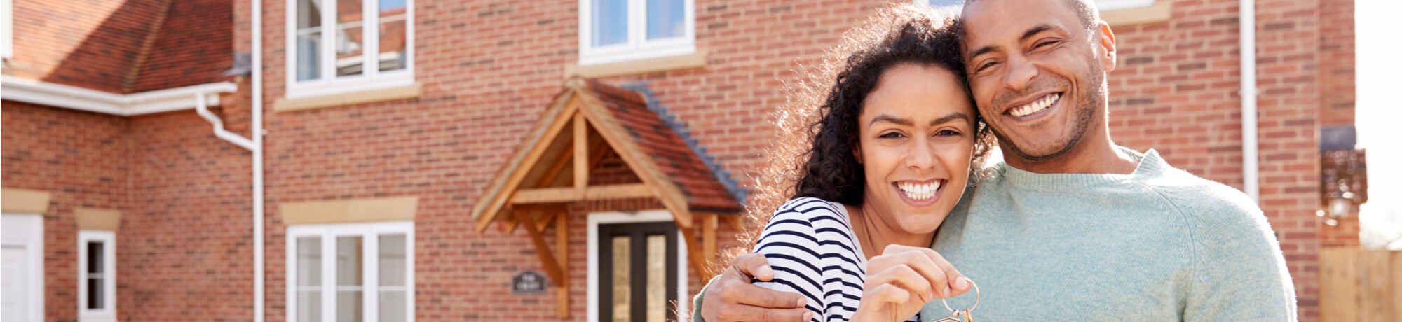 couple-holding-keys-outside-new-home