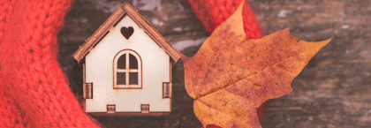 toy-house-wrapped-in-scarf-with-an-autumn-leaf