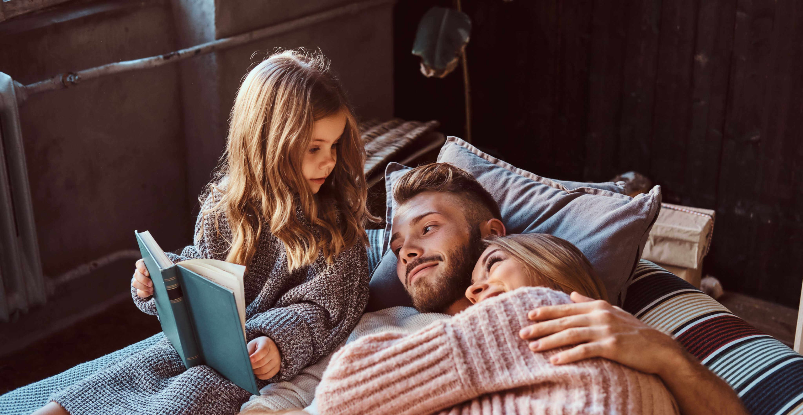 mom-dad-daughter-reading-storybook-together