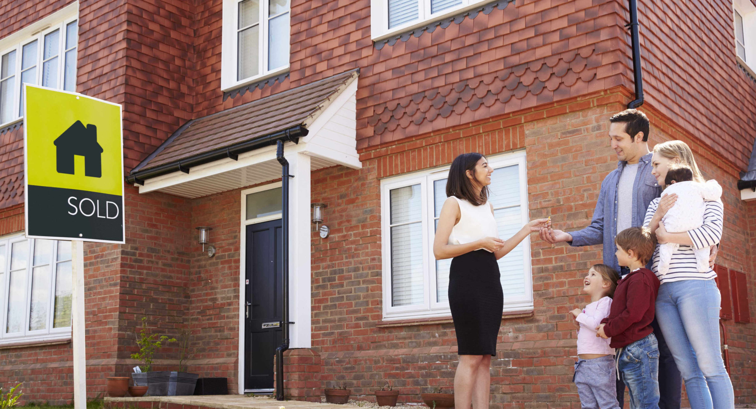 young-family-collecting-keys-new-home-2