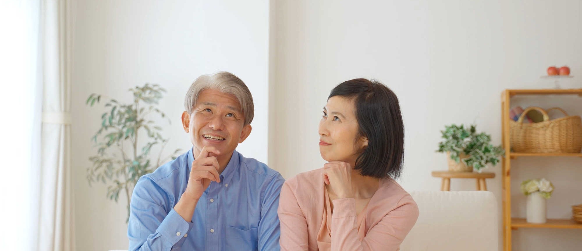 middle-aged-asian-couple-thinking-how-to-view-a-house