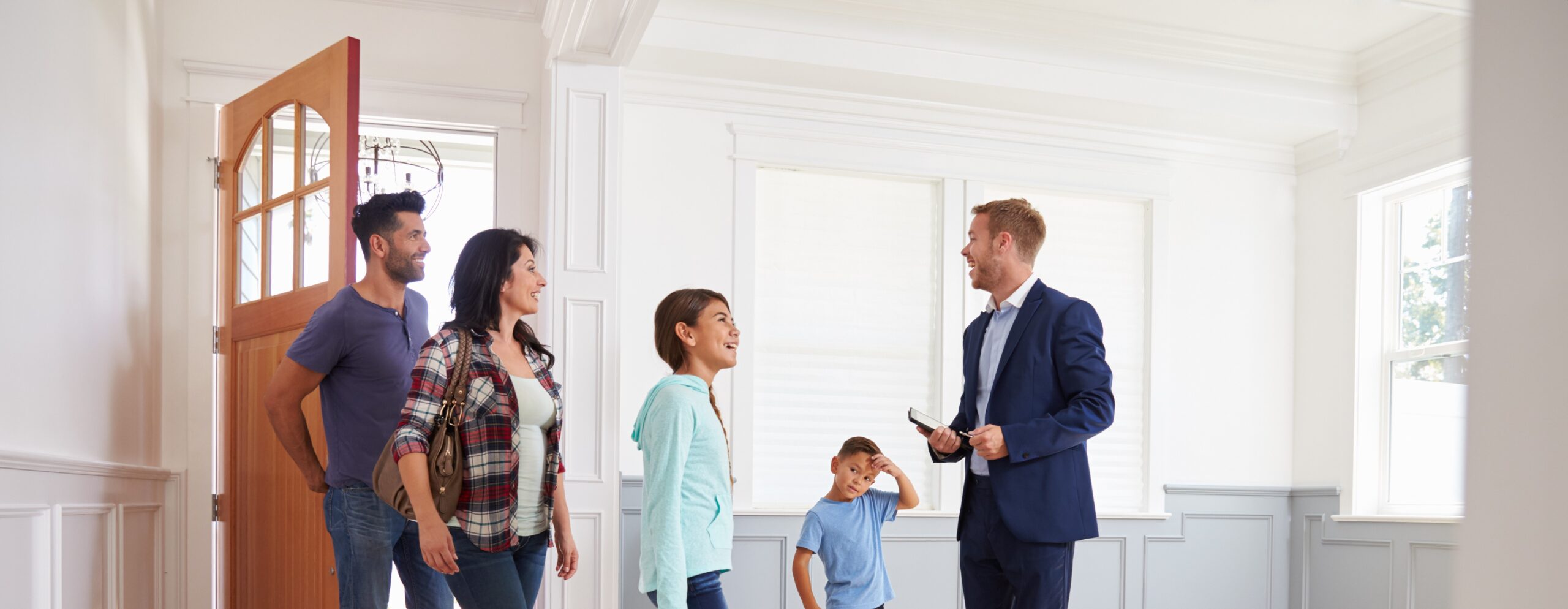 choosing-an-estate-agent-showing-family-around-new-house